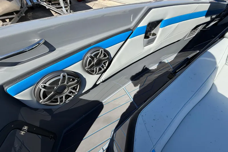 Slide: The Image of 2026 Sunsation 32 CCX boat interior with sleek design, featuring speakers and blue accents. - 35