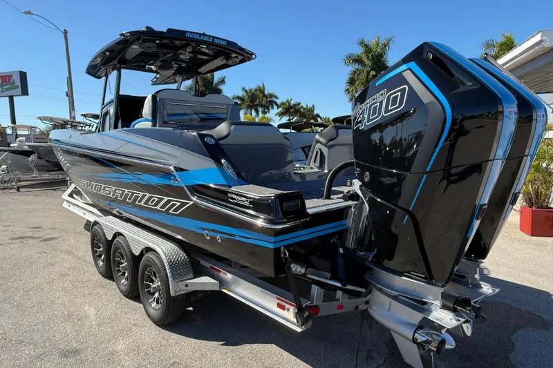 Slide: The Image of 2026 Sunsation 32 CCX boat with dual Mercury Racing 400 engines on a trailer. - 8