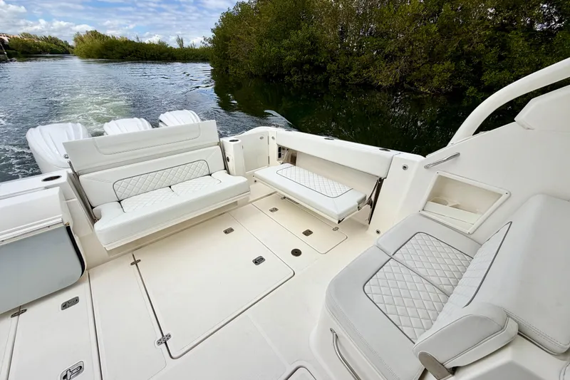 Slide: The Image of 2024 Pursuit DC 365 Dual Console boat interior with luxurious seating and scenic water view. - 11