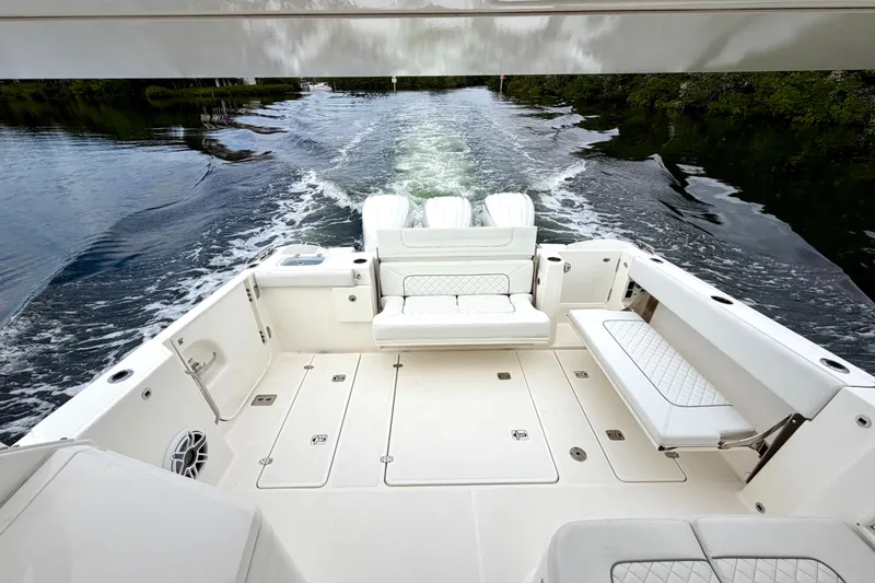 Slide: The Image of 2024 Pursuit DC 365 Dual Console boat interior with spacious seating and sleek design. - 12