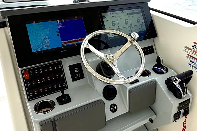 Slide: The Image of 2024 Pursuit DC 365 Dual Console helm with advanced navigation displays and controls. - 17