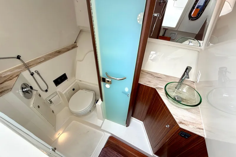 Slide: The Image of Luxurious bathroom in 2024 Pursuit DC 365 Dual Console boat with modern fixtures. - 18