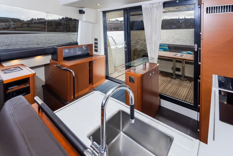 Slide: The Image of Interior of 2017 Prestige 560 yacht with modern kitchen and lake view. - 11