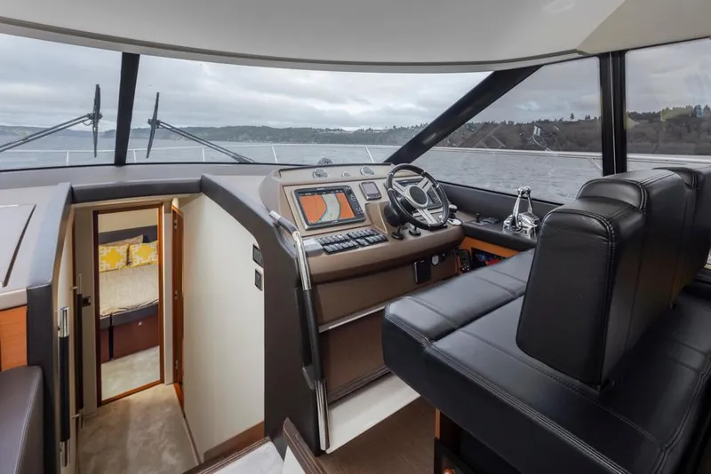 Slide: The Image of Luxurious 2017 Prestige 560 yacht interior with modern helm and panoramic views. - 18