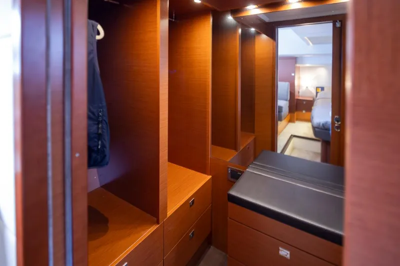 Slide: The Image of Luxurious wooden interior of 2017 Prestige 560 yacht, featuring spacious storage and elegant design. - 27