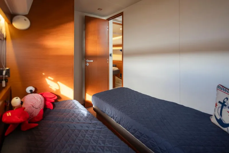 Slide: The Image of Twin cabin interior of 2017 Prestige 560 yacht with plush bedding and nautical decor. - 37