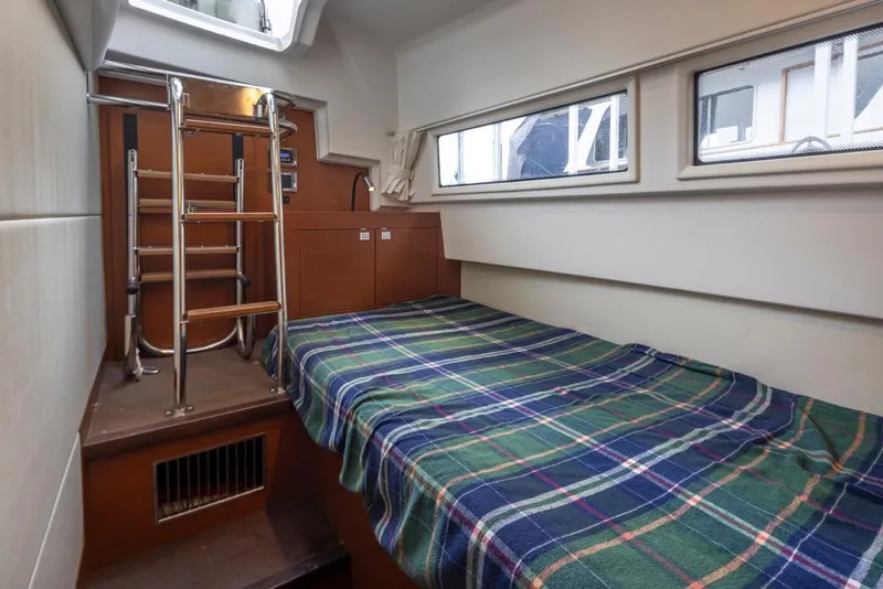 Slide: The Image of Cabin interior of 2017 Prestige 560 yacht with plaid bedspread and ladder. - 41