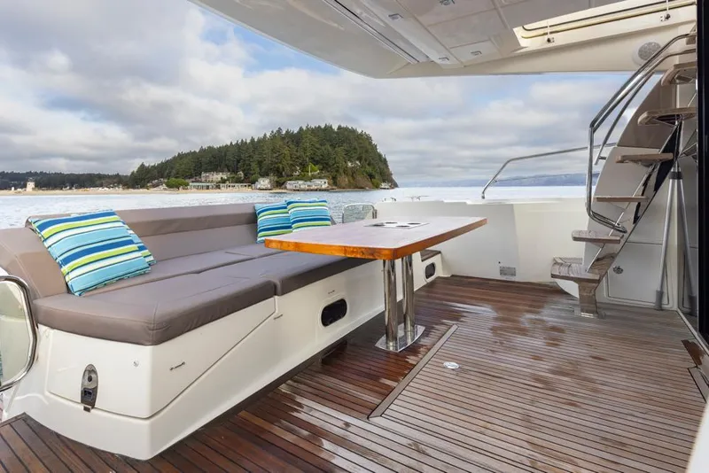 Slide: The Image of 2017 Prestige 560 yacht deck with seating, table, and ocean view. - 45
