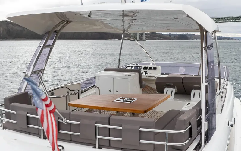 Slide: The Image of Luxurious 2017 Prestige 560 yacht with spacious deck and seating on open water. - 49