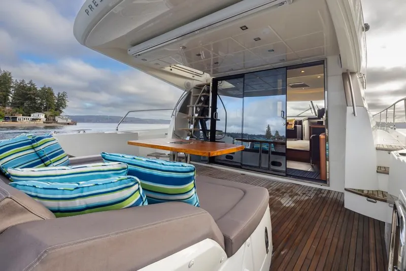 Slide: The Image of Luxury 2017 Prestige 560 yacht with outdoor seating and scenic view. - 7