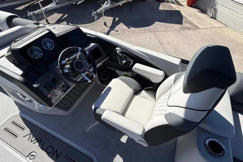 Slide: The Image of 2026 Avalon 2385 Catalina Quad Lounger helm with modern steering and controls. - 21