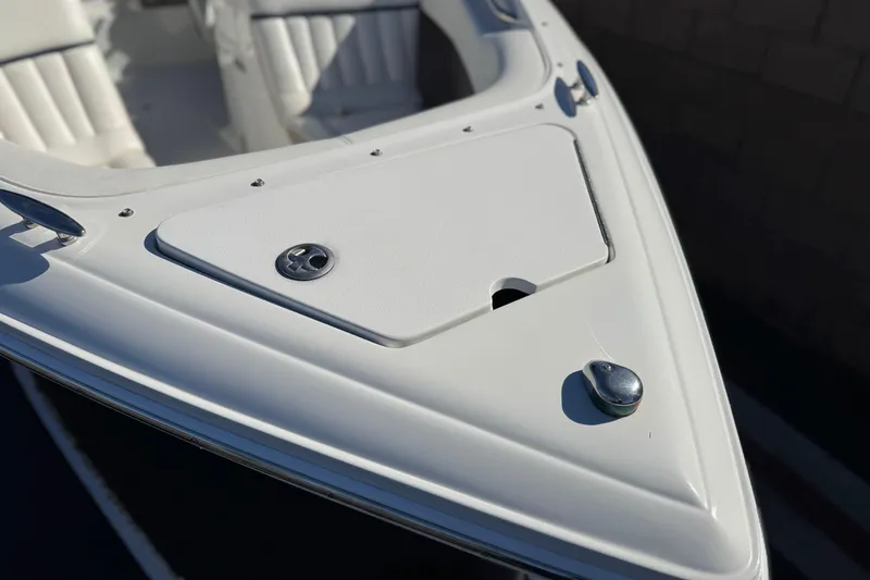 Slide: The Image of Bow of a 2005 Cobalt 200 boat with white seating and storage compartment. - 11