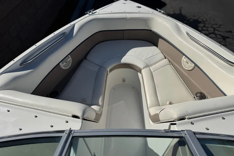 Slide: The Image of 2005 Cobalt 200 boat interior with white leather seating and cup holders. - 13