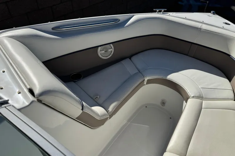 Slide: The Image of 2005 Cobalt 200 boat interior with white leather seating and speaker. - 14