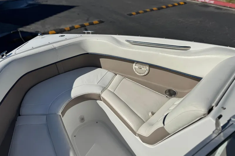 Slide: The Image of 2005 Cobalt 200 boat interior with white and beige seating, speaker, and cup holder. - 15