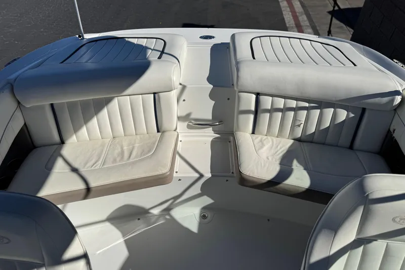 Slide: The Image of Interior of a 2005 Cobalt 200 boat with white leather seating. - 18