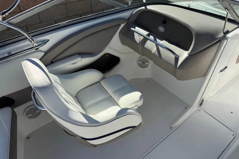 Slide: The Image of Interior of a 2005 Cobalt 200 boat with white seating and dashboard. - 21