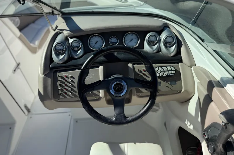 Slide: The Image of 2005 Cobalt 200 boat dashboard with steering wheel and instrument panel. - 25