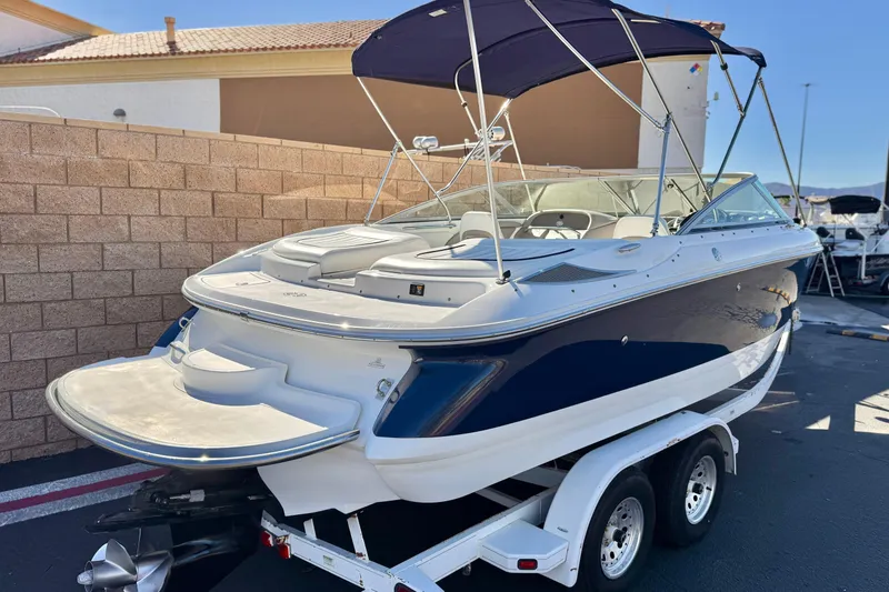 Slide: The Image of 2005 Cobalt 200 boat on trailer with blue and white exterior, parked outdoors. - 5