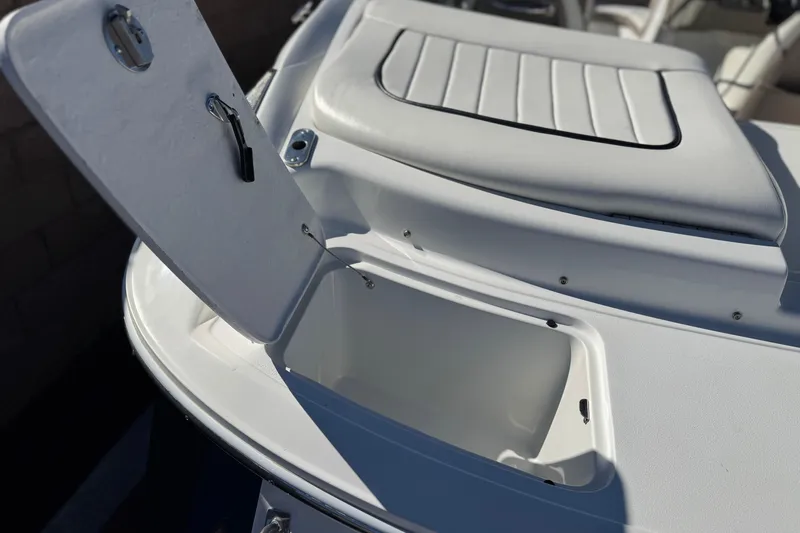 Slide: The Image of Open storage compartment on a 2005 Cobalt 200 boat, featuring sleek white design. - 7