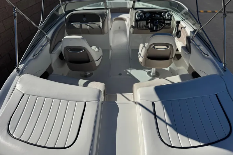 Slide: The Image of Interior of a 2005 Cobalt 200 boat with white seating and steering console. - 9