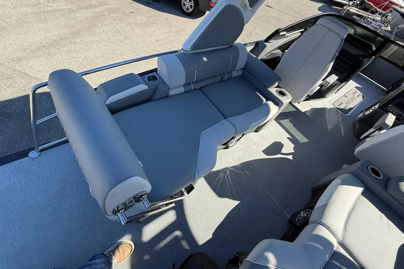 Slide: The Image of 2026 Avalon 2385 Catalina Windshield Quade Lounger interior with gray seating and cup holders. - 15