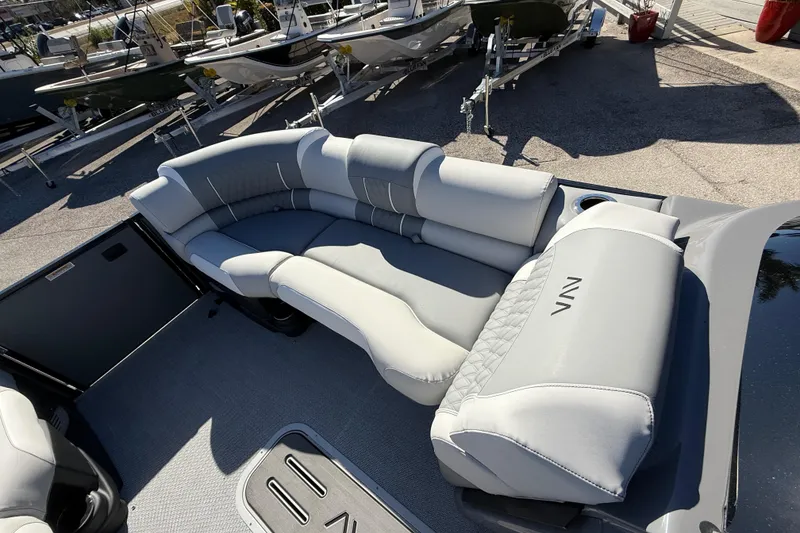 Slide: The Image of 2026 Avalon 2385 Catalina Windshield Quade Lounger with luxurious seating, parked on a sunny day. - 17