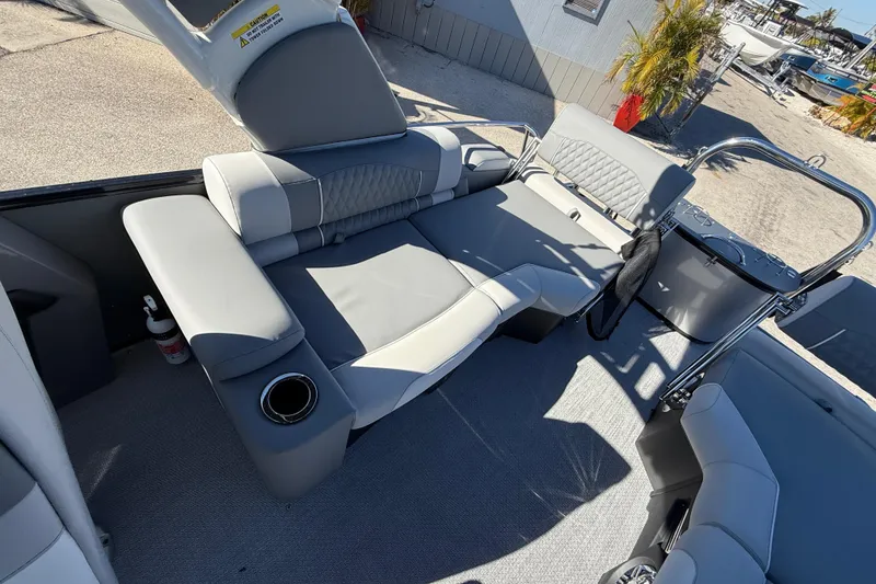 Slide: The Image of 2026 Avalon 2385 Catalina Windshield Quade Lounger interior with gray seating and cup holder. - 22