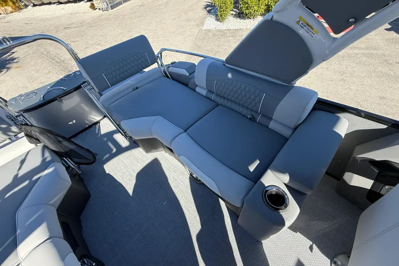 Slide: The Image of 2026 Avalon 2385 Catalina Windshield Quade Lounger interior with gray seating and cup holder. - 23