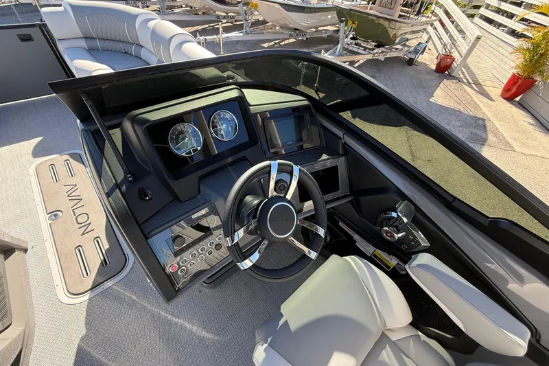 Slide: The Image of 2026 Avalon Catalina boat dashboard with steering wheel and control panel, featuring modern design. - 24