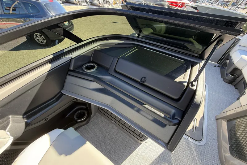Slide: The Image of 2026 Avalon 2385 Catalina Windshield Quade Lounger interior with open storage compartment. - 26