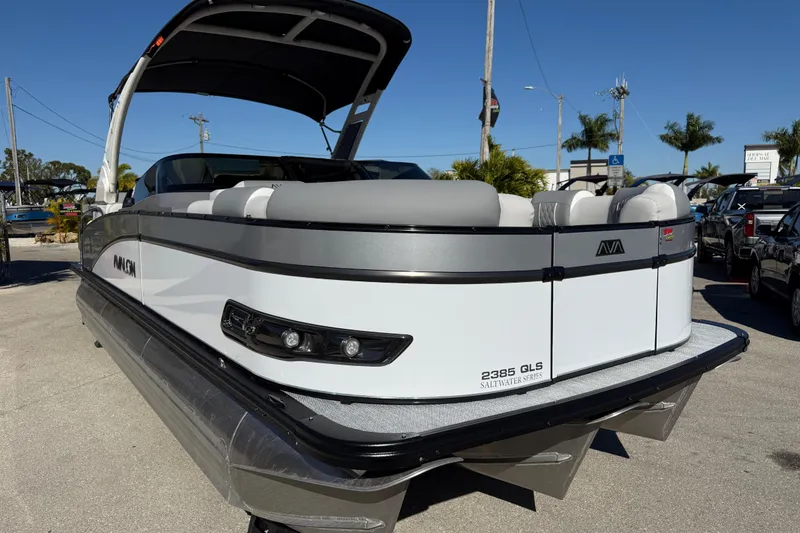 Slide: The Image of 2026 Avalon 2385 Catalina Windshield Quade Lounger, Tri Toon, High Performance boat in parking lot. - 5