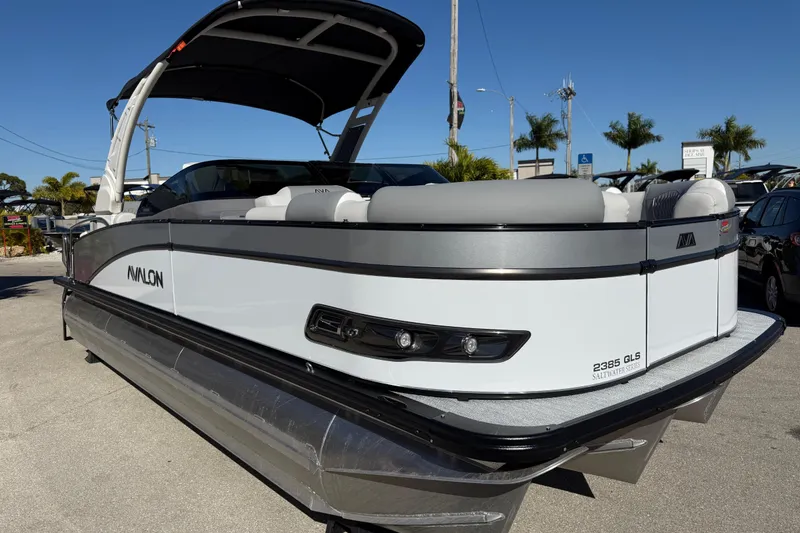 Slide: The Image of 2026 Avalon 2385 Catalina Windshield Quade Lounger, Tri Toon, High Performance boat in sunlight. - 6