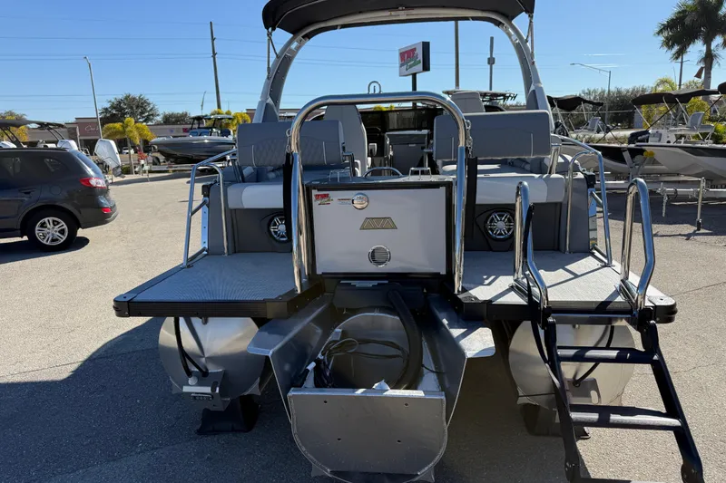 Slide: The Image of 2026 Avalon 2385 Catalina Windshield Quade Lounger Tri Toon boat in a sunny outdoor setting. - 8