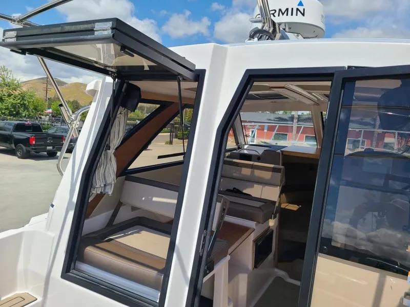 Slide: The Image of Interior view of 2023 Cutwater C-248 Coupe with open door. - 13