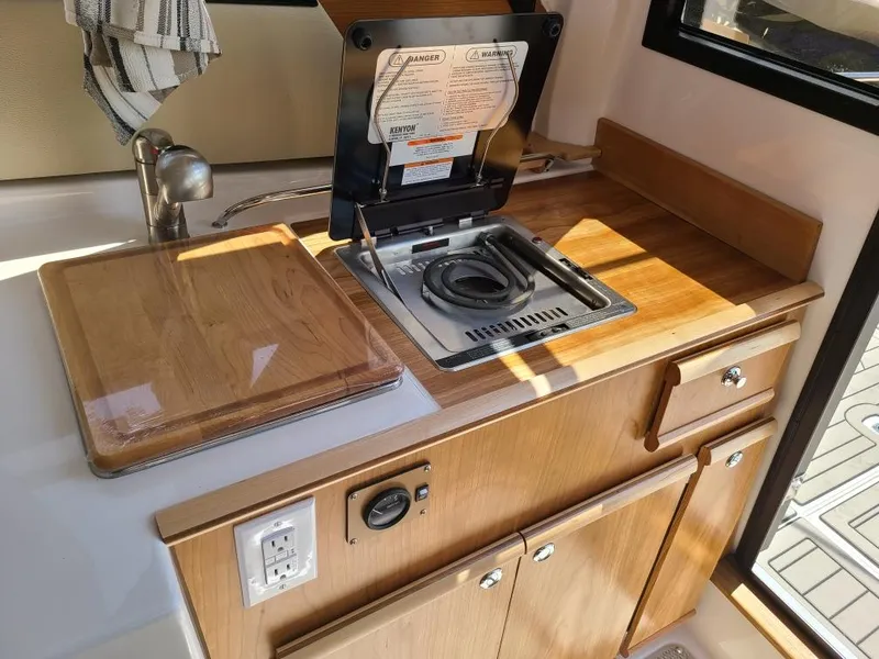 Slide: The Image of Interior of 2023 Cutwater C-248 Coupe with kitchenette and stove. - 9