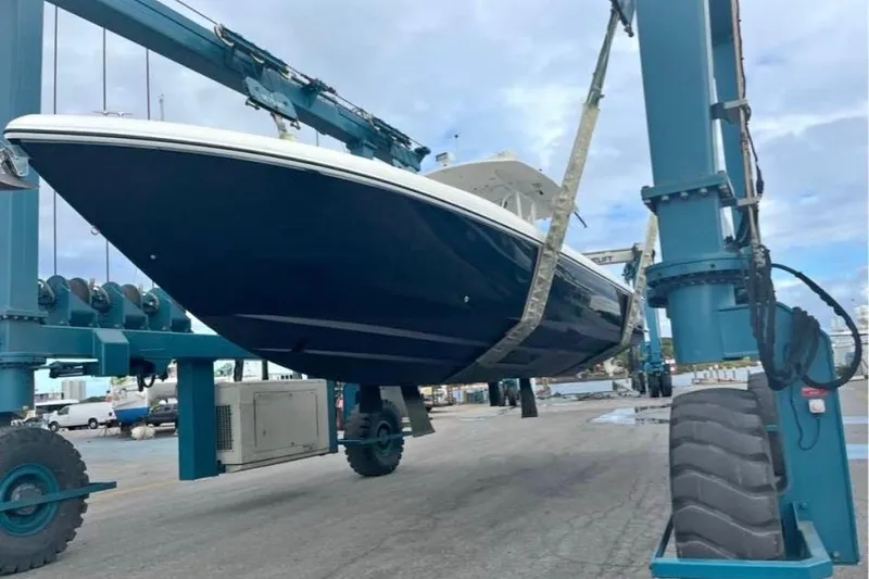 Slide: The Image of 2008 Intrepid 370 Cuddy boat on trailer, ready for transport under clear skies. - 0