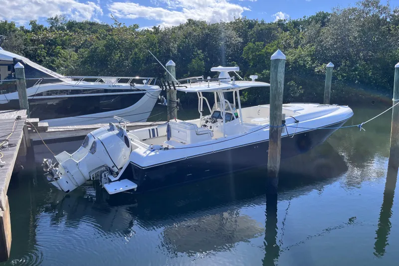 Slide: The Image of 2008 Intrepid 370 Cuddy boat lifted by crane at marina. - 1