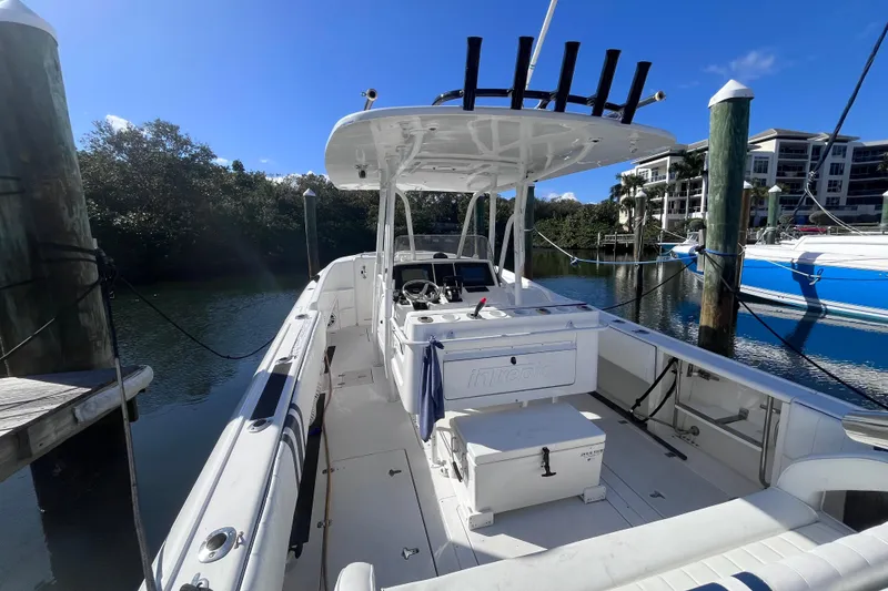 Slide: The Image of 2008 Intrepid 370 Cuddy boat, sleek design, docked on calm water. - 10