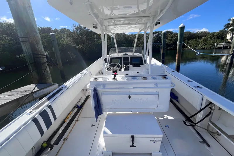 Slide: The Image of 2008 Intrepid 370 Cuddy boat docked in a marina under clear blue skies. - 11
