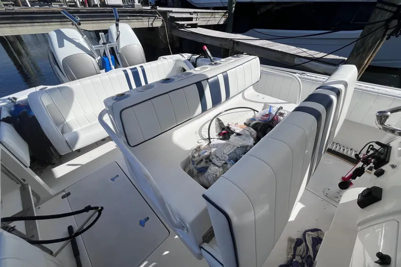 Slide: The Image of 2008 Intrepid 370 Cuddy boat interior with striped seating at marina. - 14