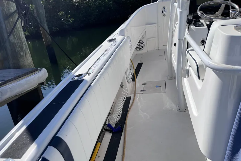 Slide: The Image of 2008 Intrepid 370 Cuddy boat docked under clear blue sky. - 21