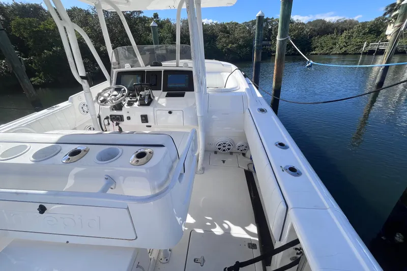 Slide: The Image of 2008 Intrepid 370 Cuddy boat interior with storage compartment and seating area. - 25