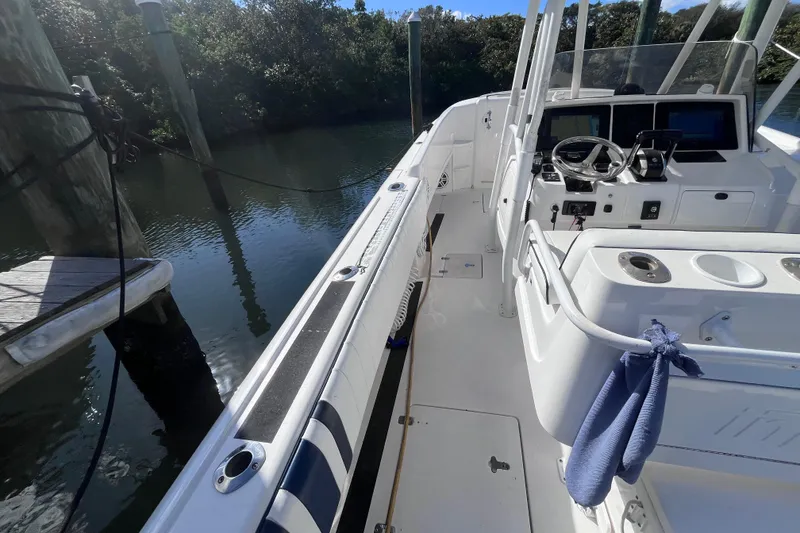 Slide: The Image of 2008 Intrepid 370 Cuddy boat interior with fishing gear and seating. - 30