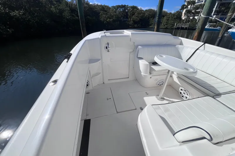 Slide: The Image of 2008 Intrepid 370 Cuddy boat interior, featuring white seating and deck details. - 32