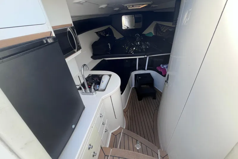 Slide: The Image of 2008 Intrepid 370 Cuddy boat with white cushioned seating and round table. - 37