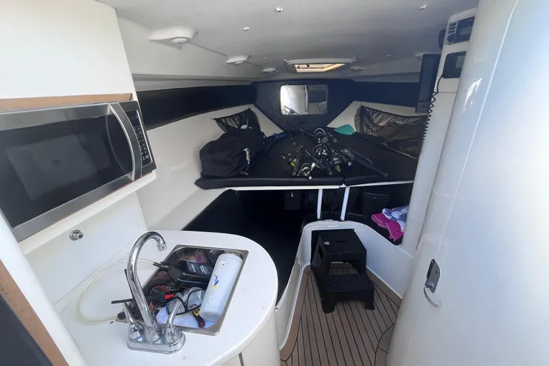 Slide: The Image of Interior of a 2008 Intrepid 370 Cuddy boat with kitchenette and sleeping area. - 38