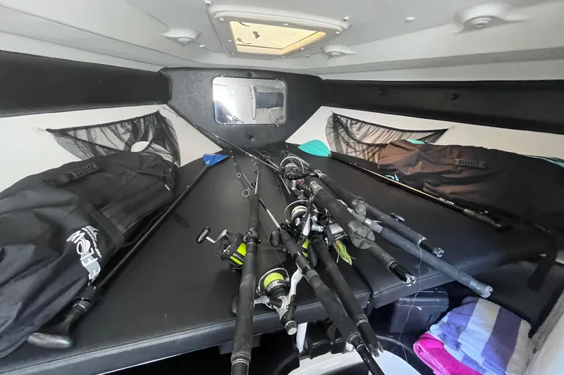 Slide: The Image of 2008 Intrepid 370 Cuddy cabin interior with fishing gear and kitchenette. - 39