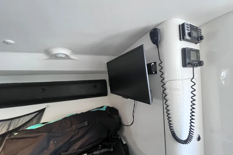 Slide: The Image of 2008 Intrepid 370 Cuddy interior with black seating, storage boxes, and a small step stool. - 41