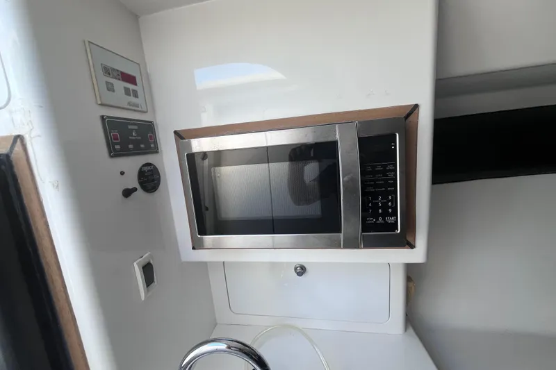 Slide: The Image of Storage compartment in a 2008 Intrepid 370 Cuddy boat, filled with bedding and clothes. - 44
